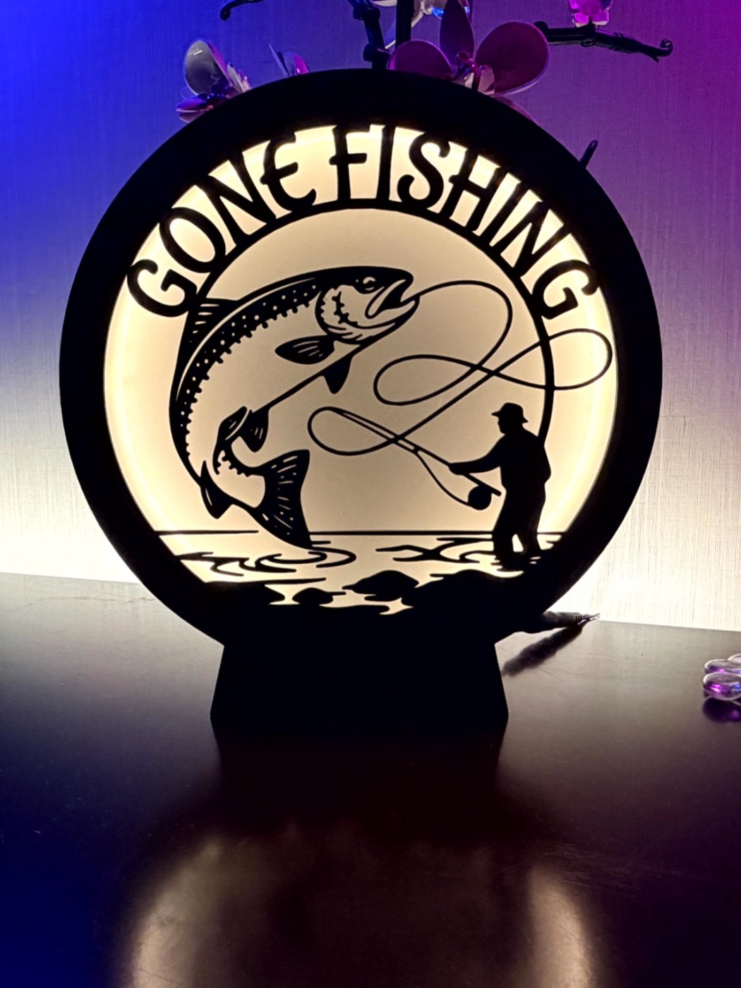 Gone Fishing circular illuminated sign with a fish and angler silhouette